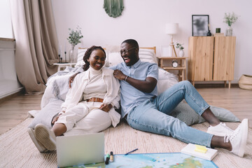 Black man and woman creating journey plan in bedroom