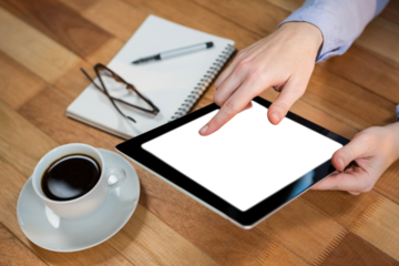 Cropped image of human hand using digital tablet