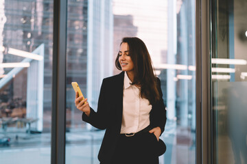 Smiling businesswoman with smartphone in office