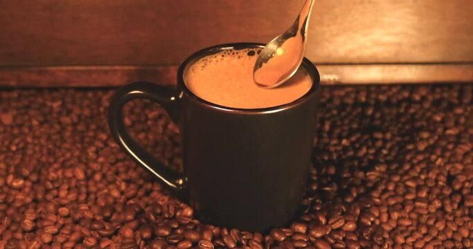 Stirring Coffee In Rich Roasted Coffee Bean Scene