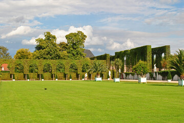 Fototapeta na wymiar View of Public Gardens with Ornate Hedging and Lawns on Sunny Day