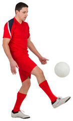 Fit football player kicking