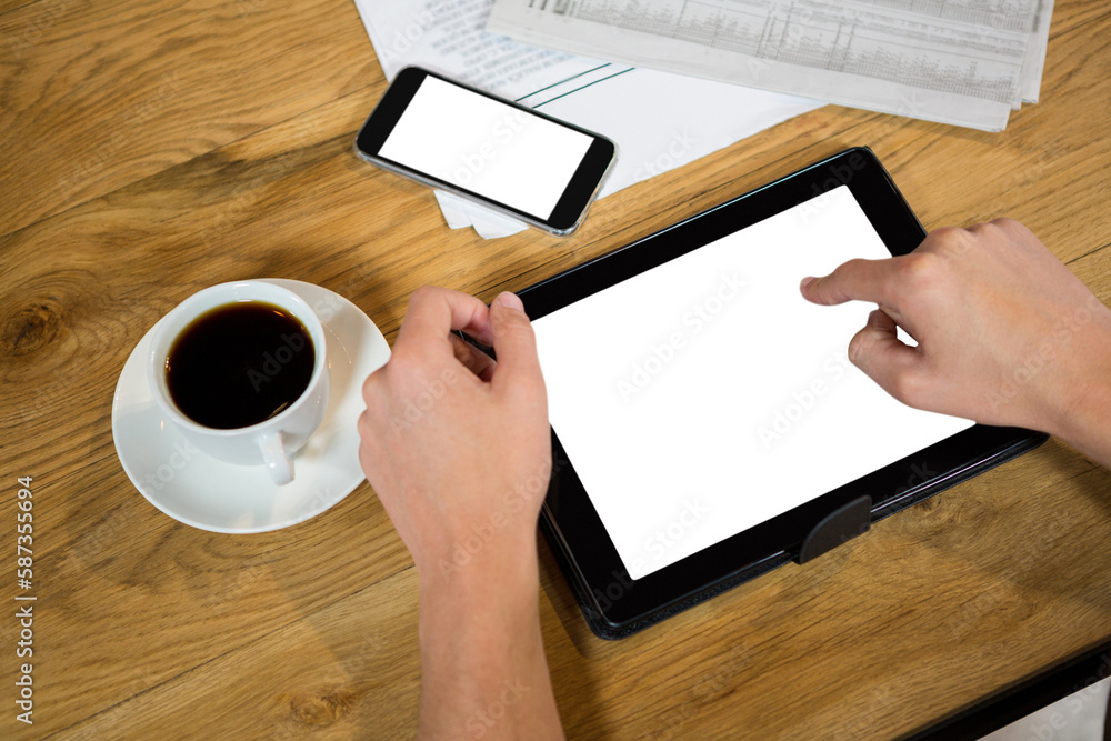 Poster cropped hands using tablet computer at table