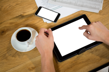 Cropped hands using tablet computer at table