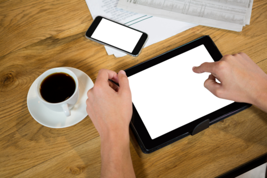 Cropped hands using tablet computer at table