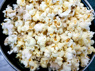 A closeup view of bowl of popcorn on a wooden table