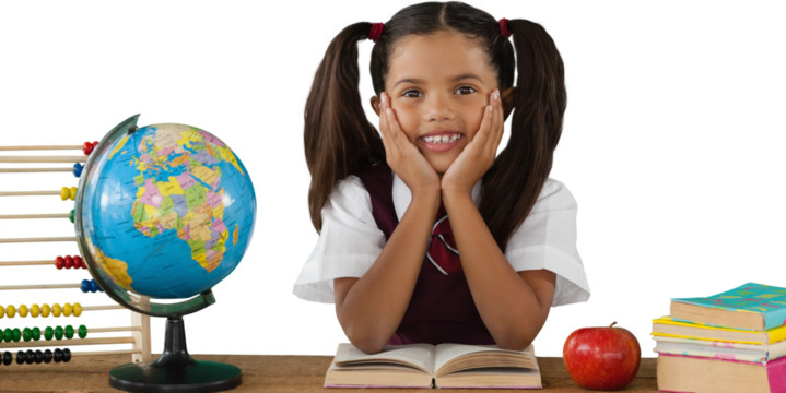 Schoolgirl leaning by globe and books