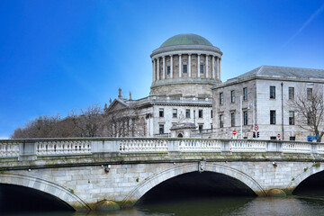 This imposing domed building beside the River Liffey is known as Four Courts, housing the Supreme...