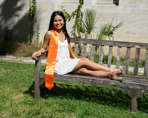 Young attractive Asian American girl posing for graduation photos from a university