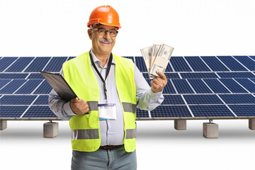 Happy male engineer with a safety vest and hardhat holding stacks of money