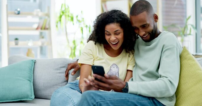 Couple, phone and laughing on sofa in home at comedy, joke or comic meme online. Interracial, cellphone and happiness of black man and woman relax on couch in lounge on social media, funny or humor.