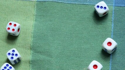 Small game dice being thrown on a table forming an abstract blank empty slide background frame, copy space in the middle. Math, random numbers, randomness, education, statistics abstract concept - Powered by Adobe