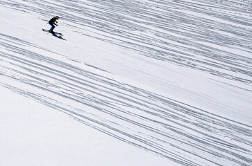 Skier skiing on the slope of the mountain