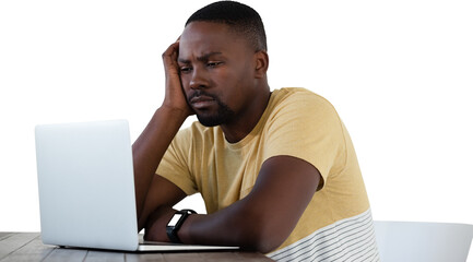 Sad young man looking into laptop