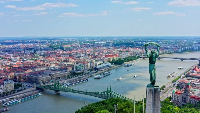 The aerial view of Budapest's city center showcases the iconic Danube river flowing through the heart of the city, with stunning view of Liberty bridge and Liberty statue 