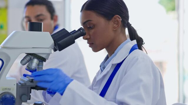 Indian scientist woman, microscope analysis or study sample for pharma product to stop virus in lab. Female science expert, data analytics or medical research in laboratory for health problem solving