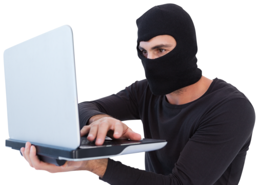 Focused burglar with balaclava holding laptop