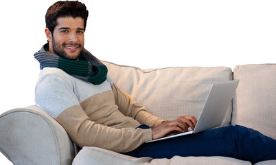 Portrait of smiling man using laptop on sofa