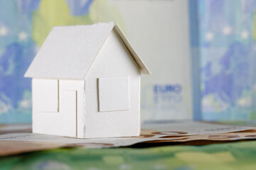 Model of detached house and European Union money