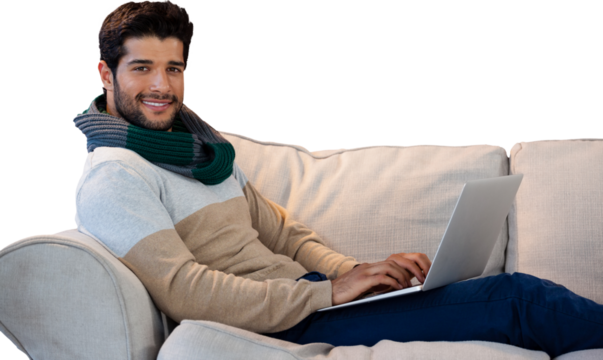 Portrait of smiling man using laptop on sofa - Powered by Adobe