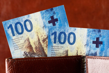 Swiss francs notes protrude from the wallet, CHF
