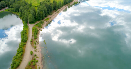 High angle view of dirt road amidst calm lake