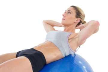 Fit woman doing sit ups on blue exercise ball