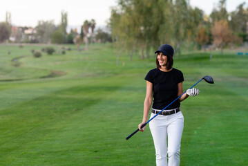 middle-aged woman walks on the golf course