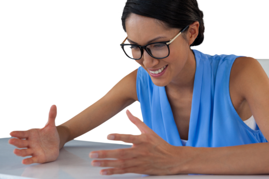 Close up of smiling businesswoman gesturing while sitting at table - Powered by Adobe