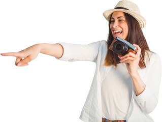 Cheerful woman pointing away while holding camera