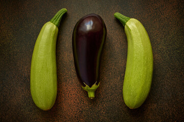 Two zucchini and eggplant on a dark background, top view, flat lay - 587371416
