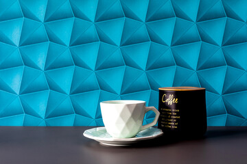 A background with blue wallpaper - colorful space. Morning coffee in an elegant style. Coffee on the table - minimalist accessories. White cups and coffee container - simplicity in an elegant style.