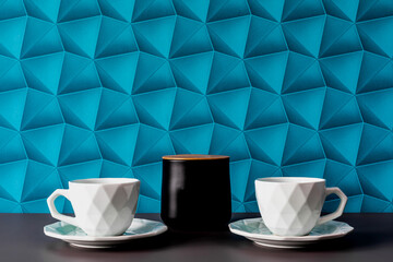 A background with blue wallpaper - colorful space. Black containers for storing sugar, tea or coffee with a wooden lid. Organization and order in the house. A white elegant cup on a saucer.