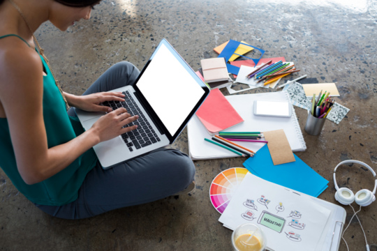 Female executive using laptop - Powered by Adobe