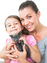 Portrait of smiling mother and daughter with cat 