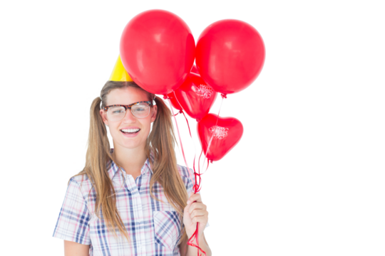 Geeky hipster smiling at camera and holding red balloons 