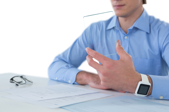 Mid section of businessman holding glass interface while working on documents