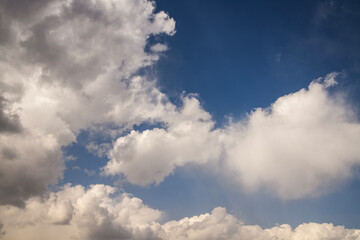 Beautiful huge fluffy clouds on the blue sky. Sky clouds background.