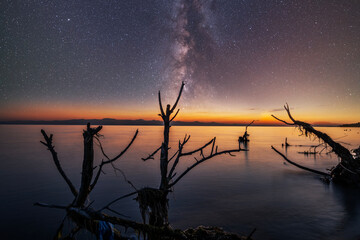 Beautiful night landscape. Bright Milky Way galaxy over the lake. 
