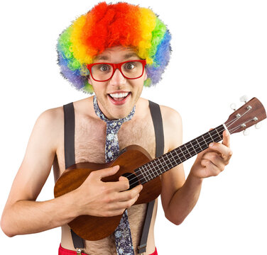 Geeky hipster in afro rainbow wig playing guitar