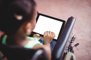 Rear view of young girl sitting on wheelchair