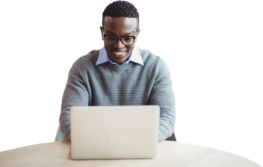 Smiling businessman using laptop at desk 
