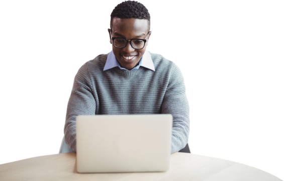 Smiling businessman using laptop at desk 