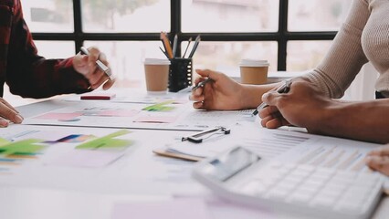 Brainstorming Collaboration and successful partnership analysis by Young business Asian people working in an office workspace