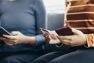 Close up of young woman holding credit card using smartphone online payment, home shopping, ecommerce, internet banking, spend money, finance, e-shop 