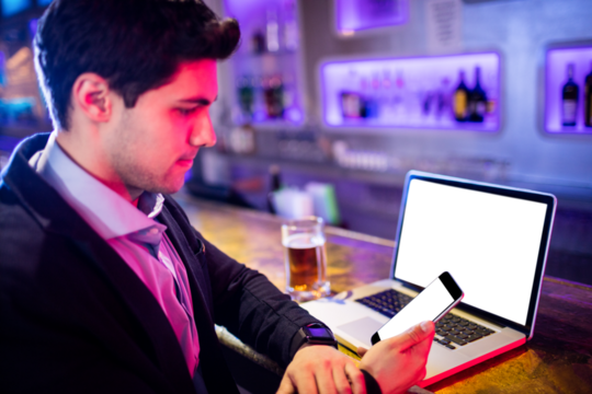 Businessman sitting with various technologies - Powered by Adobe