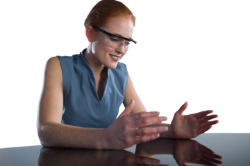 Smiling businesswoman gesturing while wearing smart glasses