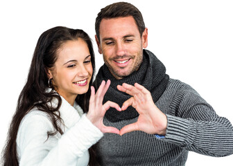 Smiling couple making heart shape with hands