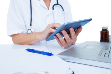 Midsection of female doctor using digital tablet