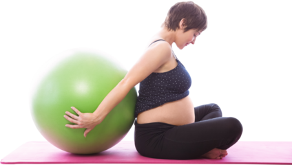 Side view of pregnent woman sitting beside exercise ball
